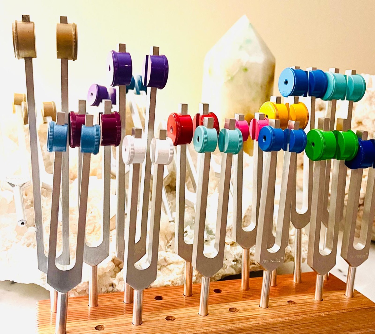 Acutonics planetary tuning forks on a wooden stand